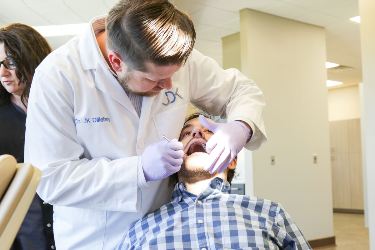 Dr. Dillehay working on a male patient's teeth