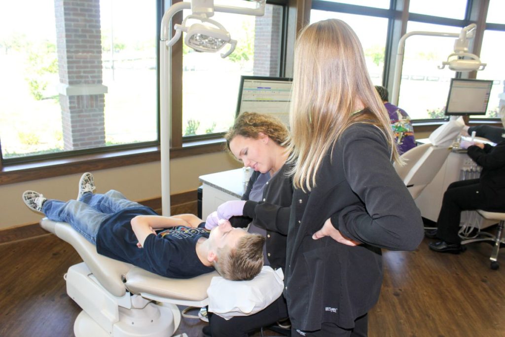 Assistants with a young patient
